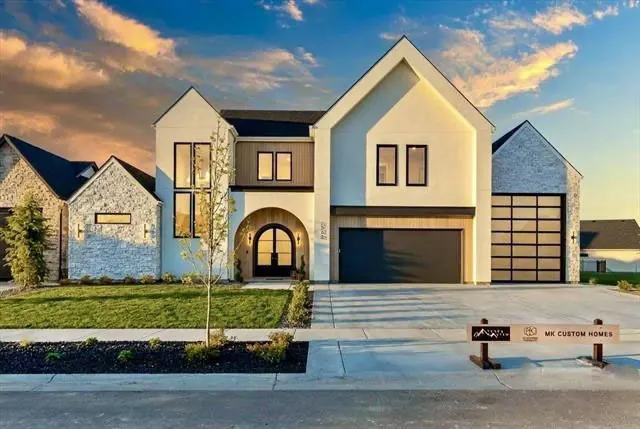 Modern farmhouse-style custom home at sunset in the Treasure Valley