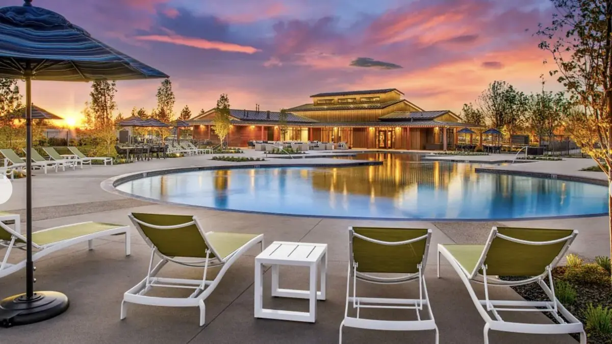 Resort-style pool and clubhouse at sunset
