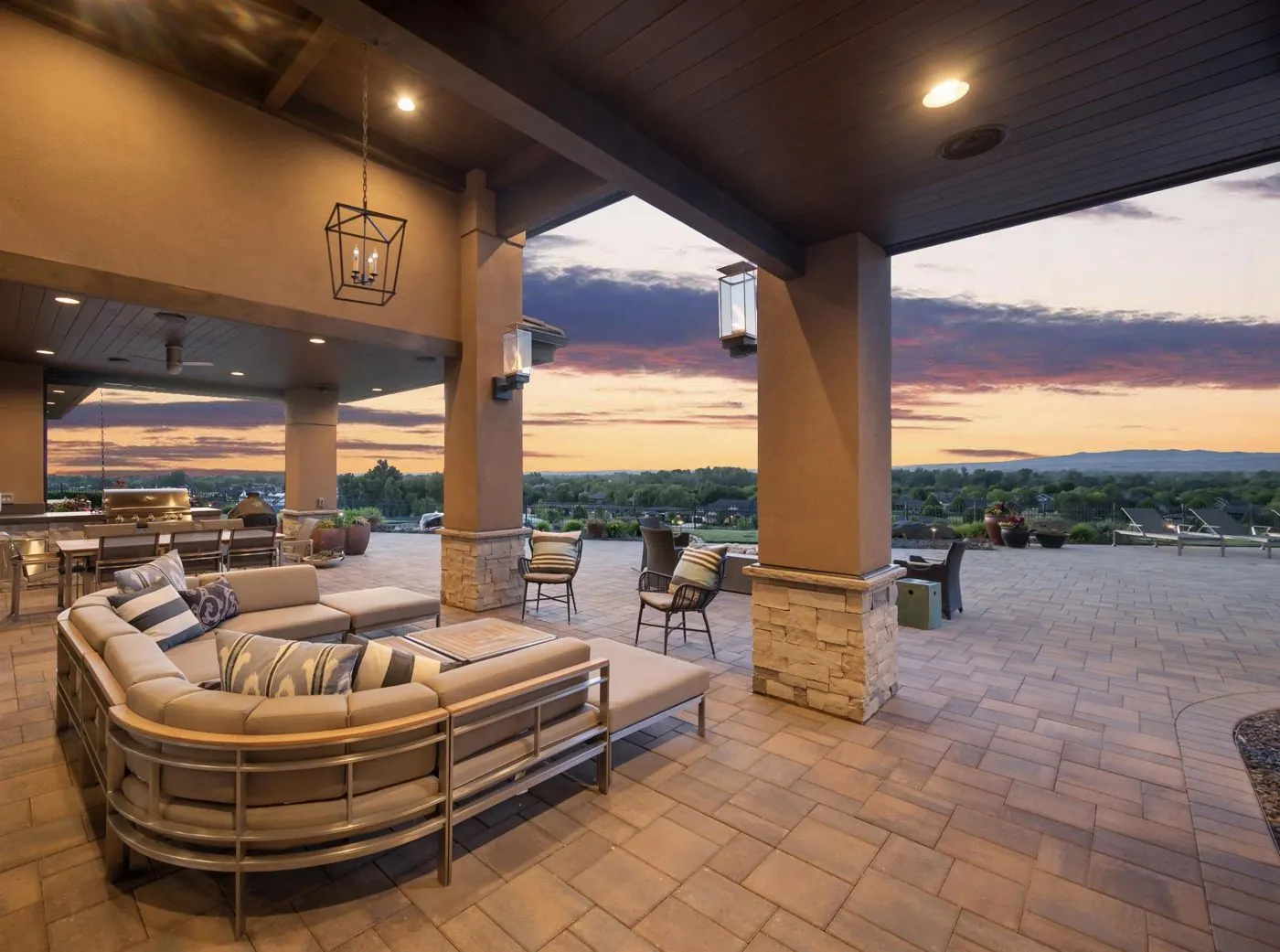 Covered patio with an outdoor kitchen overlooking the valley at sunset