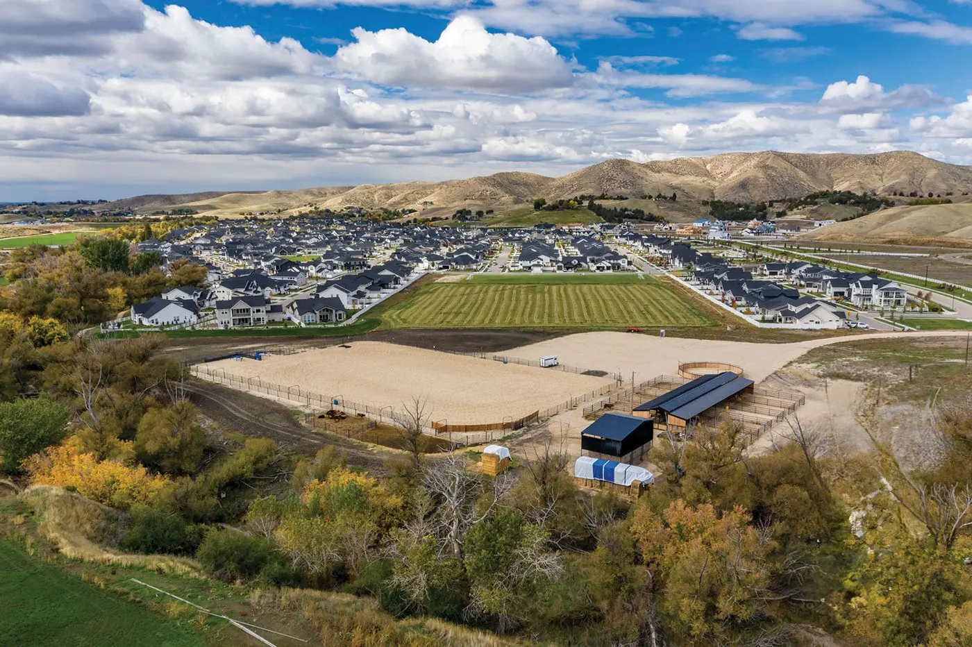 Aerial view of River Park Estates with its equestrian arena, open fields and the foothills