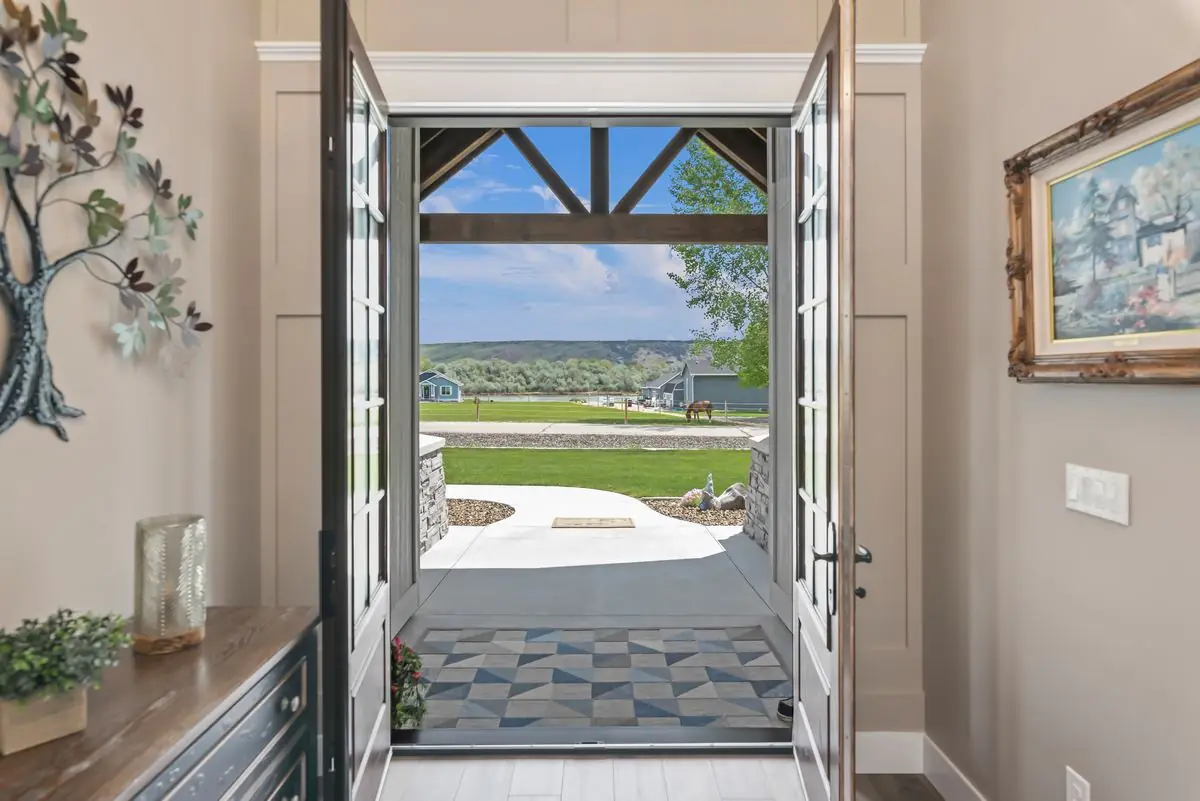 Open front door framing a view of the Idaho landscape