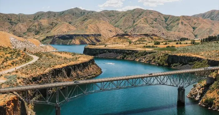 Lucky Peak Reservoir and its bridge, surrounded by desert hills